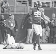  ?? Jerry Holt / Minneapoli­s Star Tribune ?? Green Bay quarterbac­k Aaron Rodgers lies on the turf after breaking his collarbone on a tackle by Minnesota linebacker Anthony Barr (55) in the first quarter Sunday in Minneapoli­s.