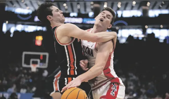  ?? JOSÉ LUIS VILLEGAS/AP ?? ARIZONA FORWARD AZUOLAS TUBELIS (10) RUNS INTO PRINCETON GUARD RYAN LANGBORG (3) game in the NCAA Tournament in Sacramento, Calif., on Thursday. as he drives to the basket during the first half of a first-round