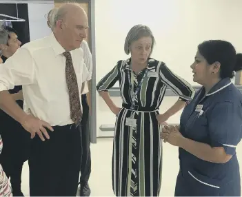  ??  ?? Vince Cable and Caroline Walker with senior staff nurse Jhancy Kannampali­l, who was in charge on Ward A8