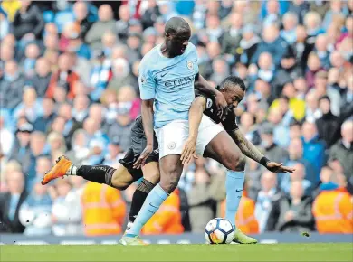  ?? RUI VIEIRA THE ASSOCIATED PRESS ?? Manchester City’s Yaya Toure, left, and Swansea’s Jordan Ayew battle for the ball during an English Premier League soccer match at Etihad Stadium in Manchester, England, on Sunday.