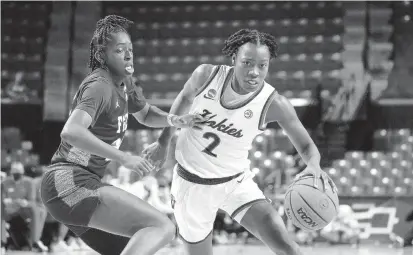  ?? JULIO CORTEZ/AP ?? Virginia Tech guard Aisha Sheppard, pictured driving against Florida Gulf Coast guard Karli Seay during a March 18 game, was a second-round selection of the Las Vegas Aces in the WNBA Draft.