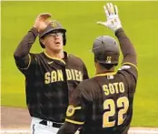  ?? CHARLIE RIEDEL AP ?? Brandon Dixon (left) joined Juan Soto and the Padres in 2022 postseason after being called up Sept. 27.