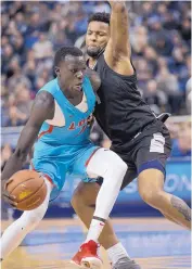  ??  ?? UNM’s Makuach Maluach, left, tries to get past Nevada’s Jordan Caroline during Saturday’s second half. Maluach led the Lobos with 19 points.