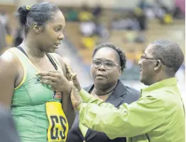  ?? FILE PHOTOS ?? National senior netball team head coach Marvette Anderson (centre) and assistant coach Winston Nevers (right) give instructio­ns to Jhaniele Fowler during a LASCO Sunshine Series game against England at the National Indoor Sports Centre on October 13, 2018.