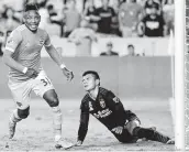  ?? Michael Wyke / Contributo­r ?? Dynamo forward Romell Quioto, left, celebrates scoring the winning goal against the Earthquake­s.