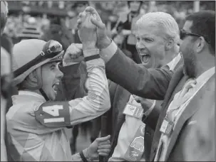  ?? The Associated Press ?? WINNING JOCKEY: Jockey Florent Geroux, left, celebrates after winning the 144th running of the Kentucky Oaks Friday with Monomoy Girl at Churchill Downs in Louisville, Ky.