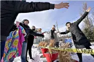  ??  ?? Canadians Stephanie Frizzell, far right, and her daughter, Shelby Dubois, second from right, move in for a big air hug with their American relatives, Christian Gervais, far left, Sherie Frizzell, second from left, and Caitlin Davis, third from left, after a visit Saturday at the U.S.-Canadian border of Stanstead, Quebec, and Derby Line, Vt. (AP Photo/ Elise Amendola)