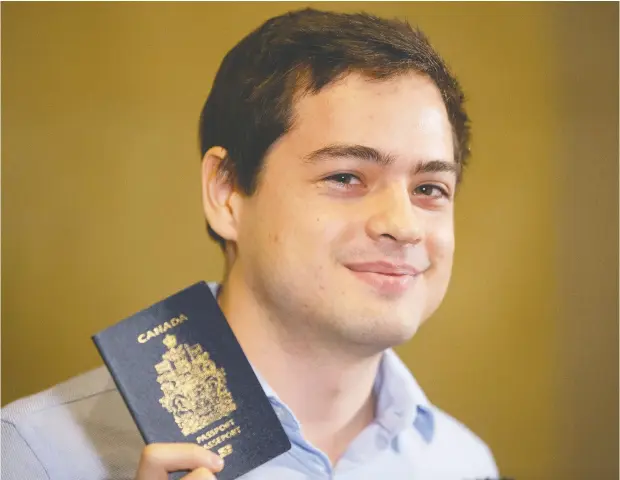  ?? CHRIS YOUNG / THE CANADIAN PRESS ?? Brandishin­g a Canadian passport, Alexander Vavilov, the Toronto-born son of Russian spies, said “I get to keep it.”