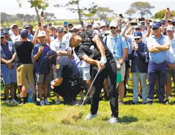  ?? K.C. ALFRED U-T ?? San Diegan Xander Schauffele hits out of the rough on the 17th hole during the first round of the U.S. Open.