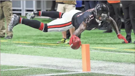  ?? Curtis Compton / Atlanta Journal-Constituti­on via AP ?? Atlanta wide receiver Julio Jones reaches to score a touchdown during the second quarter of Sunday’s game against the Tampa Bay Buccaneers in Atlanta.