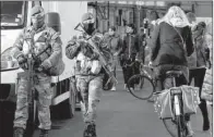  ?? AP/VIRGINIA MAYO ?? Belgian soldiers patrol Monday in the center of Brussels. Belgian Prime Minister Charles Michel announced Brussels would remain at the highest alert level for at least another week.