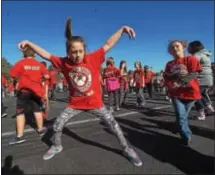  ??  ?? French Creek Elementary School fourth-grade students, Alexis Little and Cadence Helms took part in a dance party following the walkathon.