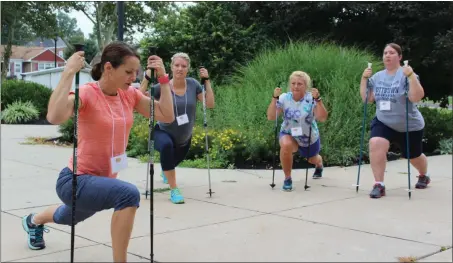  ?? MEDIANEWS GROUP FILE PHOTO ?? Lucie Bergeyova, far left, leads a seminar in Nordic Walking at the Pottstown Middle School. The group used the walking poles to do several stretches during the session.