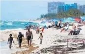  ?? AMY BETH BENNETT/SOUTH FLORIDA SUN SENTINEL ?? Beachgoers visit Fort Lauderdale Beach on Thursday.