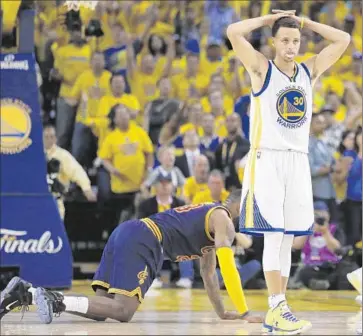  ?? Ben Margot Associated Press ?? STEPHEN CURRY REACTS after being called for a foul on LeBron James, on the f loor, during the second half of Game 2, won by the Cavaliers. Neither star is shooting well in the first two games of the Finals.