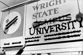  ??  ?? Wright State’s first president, Brage Golding, points at a former Wright State Campus sign. Wright State University became an independen­t institutio­n in 1967.