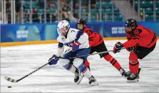  ?? JONATHAN NACKSTRAND OIS VIA AP ?? Shaeffer Gordon-Carroll, of USA skates with the puck while under pressure from Markus Ruck and Adam Valentini, of Canada, in the Ice Hockey Men’s 6-on-6 Tournament Semifinals between Canada and USA at the Gangneung Hockey Centre during the Winter Youth Olympic Games, in Gangwon, South Korea on Jan. 30.