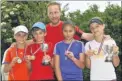  ?? Picture: Tony Flashman FM3891154 ?? From left, under-12s runnerup Louis Temple and winner Rory Marles, coach Simon Grieve with under-14s girls’ runner-up Rebecca Curland and winner Emma Slack