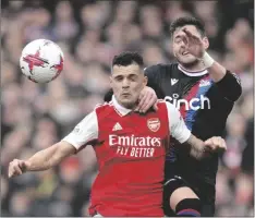  ?? AP PHOTO/KIRSTY WIGGLESWOR­TH ?? Crystal Palace’s Joel Ward (right) challenges for the ball with Arsenal’s Granit Xhaka during the English Premier League soccer match between Arsenal and Crystal Palace at Emirates stadium in London, on Sunday.