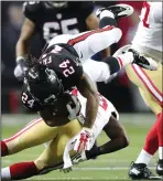  ?? CURTIS COMPTON/TRIBUNE NEWS SERVICE ?? Left: Atlanta Falcons running back Devonta Freeman soars over San Francisco 49ers defender Jaquiski Tartt for a first down on Sunday in Atlanta, Ga.