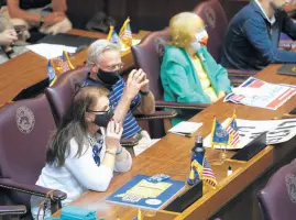  ?? DARRON CUMMINGS/AP ?? Guests listen during a public hearing on the redistrict­ing plan at the Statehouse on Thursday in Indianapol­is.