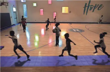  ?? FRED SQUILLANTE/COLUMBUS DISPATCH ?? Children run around the perimeter of the basketball court Aug. 13 at the Boys & Girl Clubs’ Reeb Avenue Center on the South Side.