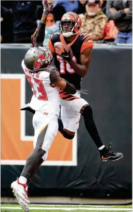  ?? ANDY LYONS / GETTY IMAGES ?? Bengals wideout A.J. Green catches a touchdown pass in Sunday’s 37-34 win over Tampa Bay. Green appeared to injure his foot on a catch late in the game.