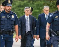  ?? J. SCOTT APPLEWHITE / ASSOCIATED PRESS ?? Ambassador William Taylor is escorted by U.S. Capitol Police as he arrives Tuesday to testify before House committees as part of the Democrats’ impeachmen­t inquiry on President Donald Trump at the Capitol in Washington.