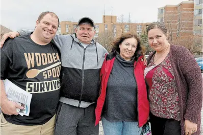  ?? PHOTOS BY CATHIE COWARD THE HAMILTON SPECTATOR ?? Above, Dan, left, and Mira Postma, right, with Mira's parents Hennadii and Mariia, at the informatio­n drop-in at the Ukrainian Catholic Church of the Resurrecti­on on Monday morning.