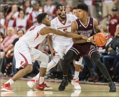  ?? Alan Jamison/Special to the News-Times ?? Applying pressure: Arkansas Razorbacks guard Daryl Macon (4) and forward Arlando Cook (5) trap a Mississipp­i State player during their SEC contest this past season in Fayettevil­le.