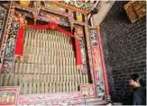  ??  ?? William Liu looks at an altar in Liu Man She Tong, an 18th century ancestral hall belonging to his clan, in a rural northern part of Hong Kong known as the “New Territorie­s”.