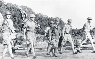  ?? IWM ?? ●● British commander Lieutenant-General Percival (far right) on his way to negotiate the surrender of Singapore, 15 February 1942