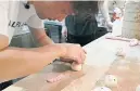  ??  ?? Chef Keung Mak rolls the body of a pigshaped dumpling in his kitchen — the start of a sure-fire Instagram favourite.