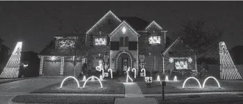  ?? Brett Coomer / Houston Chronicle ?? Tara Gallagher dances in front of her family’s home decorated to honor the Astros’ World Series win.