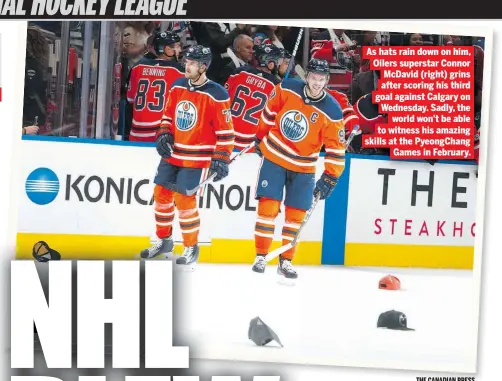  ?? THE CANADIAN PRESS ?? As hats rain down on him, Oilers superstar Connor McDavid (right) grins after scoring his third goal against Calgary on Wednesday. Sadly, the world won’t be able to witness his amazing skills at the PyeongChan­g Games in February.