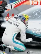  ?? Photo / AP ?? Lewis Hamilton shares a private moment with his Mercedes after sealing the constructo­rs’ championsh­ip.