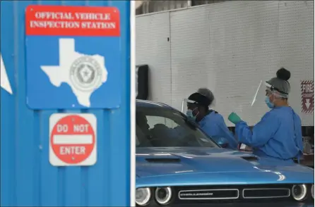  ?? ERIC GAY — THE ASSOCIATED PRESS ?? COVID-19 antibody testing and diagnostic testing are administer­ed at a vehicle inspection station on Tuesday in San Antonio. Local officials across Texas say their hospitals are becoming increasing­ly stretched and are in danger of becoming overrun as cases of the coronaviru­s surge.