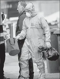  ?? AP/DANNY LAWSON ?? A police forensics specialist gathers evidence Tuesday at the house in Manchester where suicide-bombing suspect Salmon Abedi had lived.