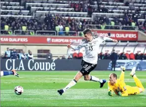  ?? AZIZ KARIMOV / AP ?? Thomas Mueller scores Germany's second goal during Sunday’s 4-1 victory over Azerbaijan in their World Cup Group C qualifying match in Baku.