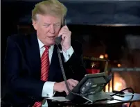  ?? — Reuters ?? Donald Trump participat­es in NORAD Santa tracker phone calls from the White House in Washington.