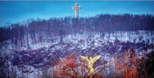  ?? JOHN MAHONEY/MONTREAL GAZETTE ?? The cross is ubiquitous in Quebec’s landscape, from the illuminate­d one that towers over Mount Royal, above, to the cruciform shape of Place Ville Marie’s office complex to our flags — the intersecti­ng thick red bars on Montreal’s and the white ones on Quebec’s.