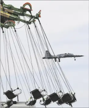  ?? Buy this photo at yumasun.com PHOTO BY RANDY HOEFT ?? A U.S. MARINE CORPS VMFT-401 “Sniper” F-5N Tiger II is seen making an approach to Marine Corps Air Station Yuma during the opening day of the 2022 Yuma County Fair in this March 31 photo. In the foreground is one of the rides at the fair.