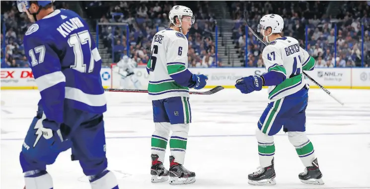  ?? — AP ?? ‘The power play is really simple,’ says Sven Baertschi, left, with teammate Brock Boeser. ‘It’s just a bunch of two-on-ones all over the ice.’