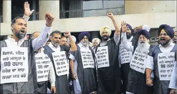  ??  ?? ■ SAD president Sukhbir Singh Badal (4L) and the party’s other MLAs wear black robes and raise slogans over the state government’s failure in keeping its promise of complete debt waiver. KESHAV SINGH /HT