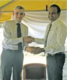  ?? Photo: Ashna Kumar ?? UNDP country director and head of regional programme and policy support, Bakhodir Burkhanov (left) hands over the keys of the newly donated vehicles to the Permanent Secretary of the Ministry of Environmen­t, Joshua Wycliffe during the hand-over...