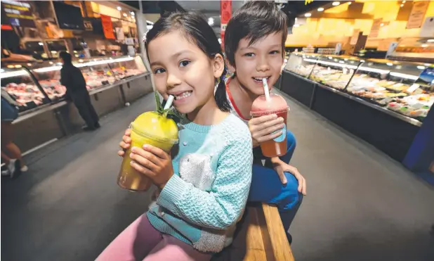  ?? Picture: TONY GOUGH ?? WAY TO GO: Louisa, 6, and Ben Jennings, 8, enjoying a drink with a paper straw. Coca-Cola is joining the ban on plastic straws.