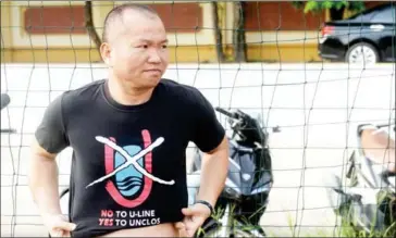  ?? HOANG DINH NAM/AFP ?? Le Hoang, a member of the No-U FC football team, puts on a T-shirt as he prepares to play a match at a pitch in Hanoi on July 9.