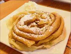  ?? ?? The Frumple, a pancake swirled into a rosette and topped with cinnamon sugar, is a signature item at The Skinny Pancake.