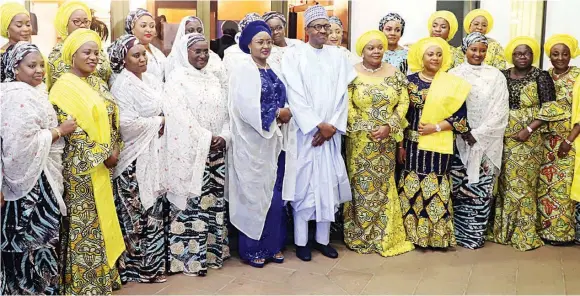  ??  ?? President Muhammadu Buhari ( middle); his wife, Aisha (fifth left) and wives of governors at the State House in Abuja...at the weekend. PHOTO: PHILIP OJISUA