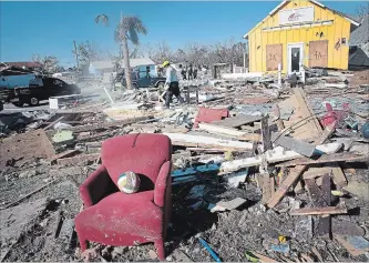  ?? SCOTT OLSON GETTY IMAGES ?? Search-and-rescue team members search for victims of hurricane Michael in Mexico Beach, Fla. Michael slammed into the Florida Panhandle causing massive damage and claiming the lives of 17 people.